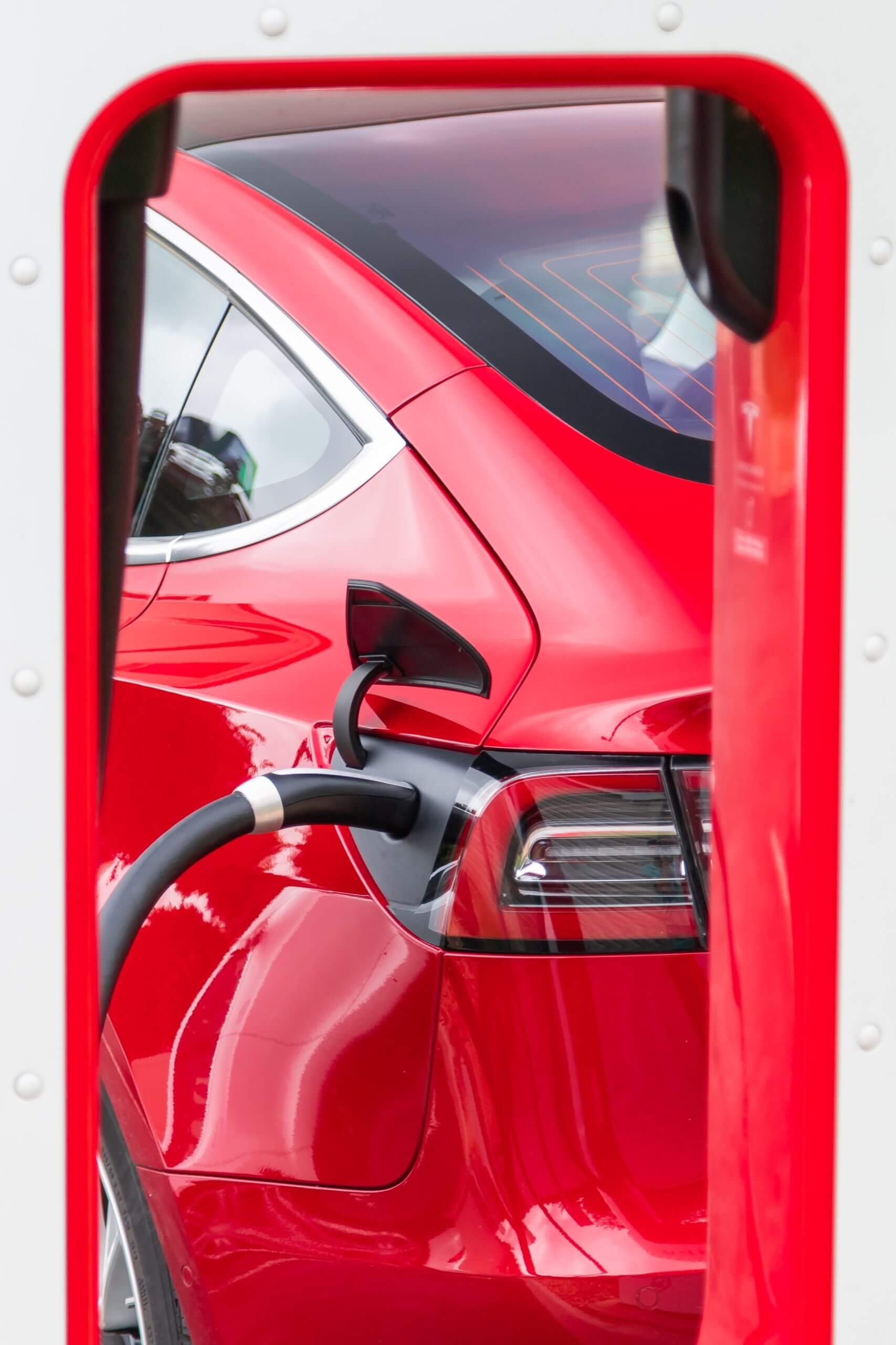 Red electric car being recharged